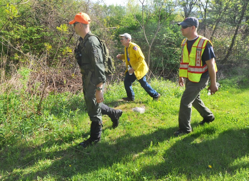 A Vermont State Police officer and Rutland Town Fire Department firefighters continue their search through the woods in Center Rutland Friday morning around 8 a.m., based on the report of a missing girl received by police late Thursday.