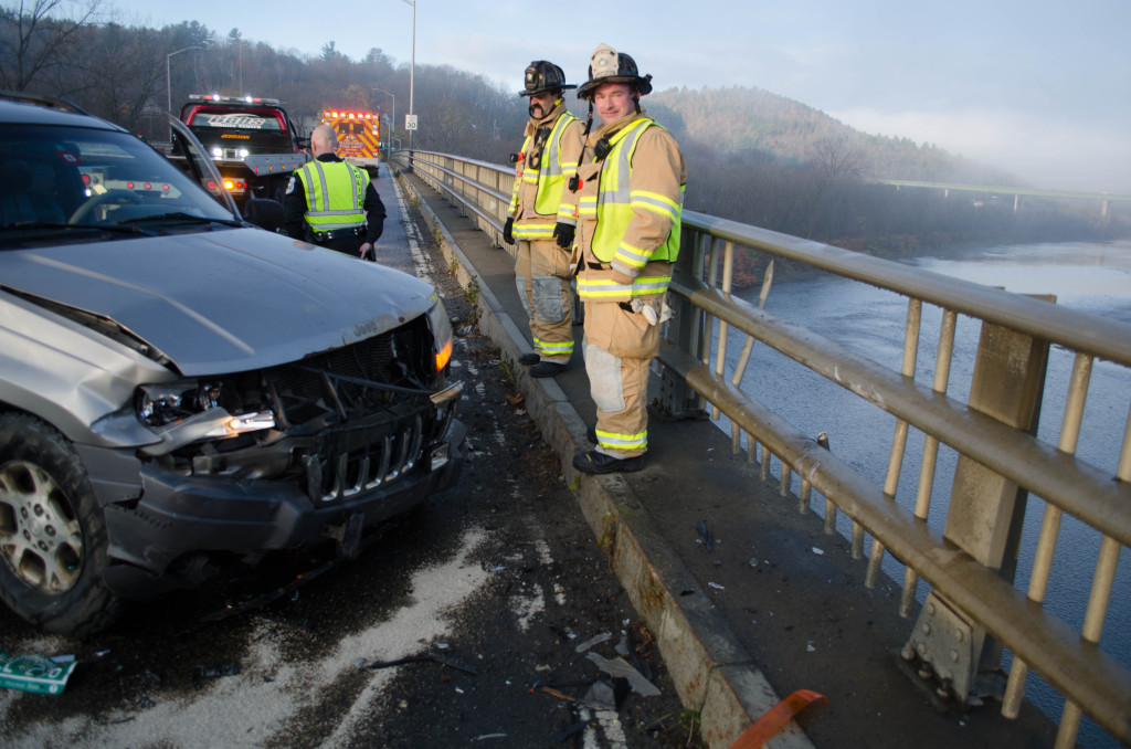 ERIC FRANCIS PHOTO Icing on the Urban Bridge in downtown White River Junction first thing Friday morning sent a Jeep straight into the railing, knocking several pieces into the White River far below.  The driver sustained rib injuries and she was taken to the hospital by Hartford firefighters.