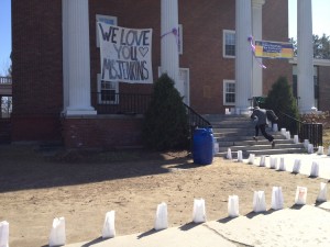 A hand-written sign on the front of Fuller Hall at St. Johnsbury Academy reads "We Love you Miss Jenkins"