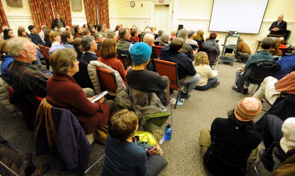 Albert J. Marro / Staff Photo Author and environmentalist Bill McKibben, top right, spoke to an overflow crowd on Climate Change Wednesday evening in the Nellie Grimm Fox Room at the Rutland Free Library. 