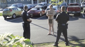 Photo by Eric Francis Dylan Gingues (in a loincloth) engages Officers Logan Scelza and Sean Fernandes in a debate about his Constitutional rights in Hartford Wednesday.